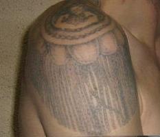 Zek's shoulder with an eaulette tattoo